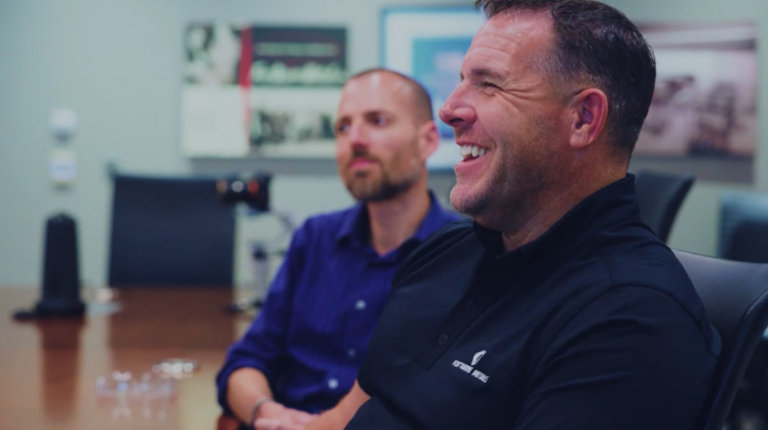 Evan Wood, EVP, People & Strategy at Fort Wayne Metals, laughing with employees.